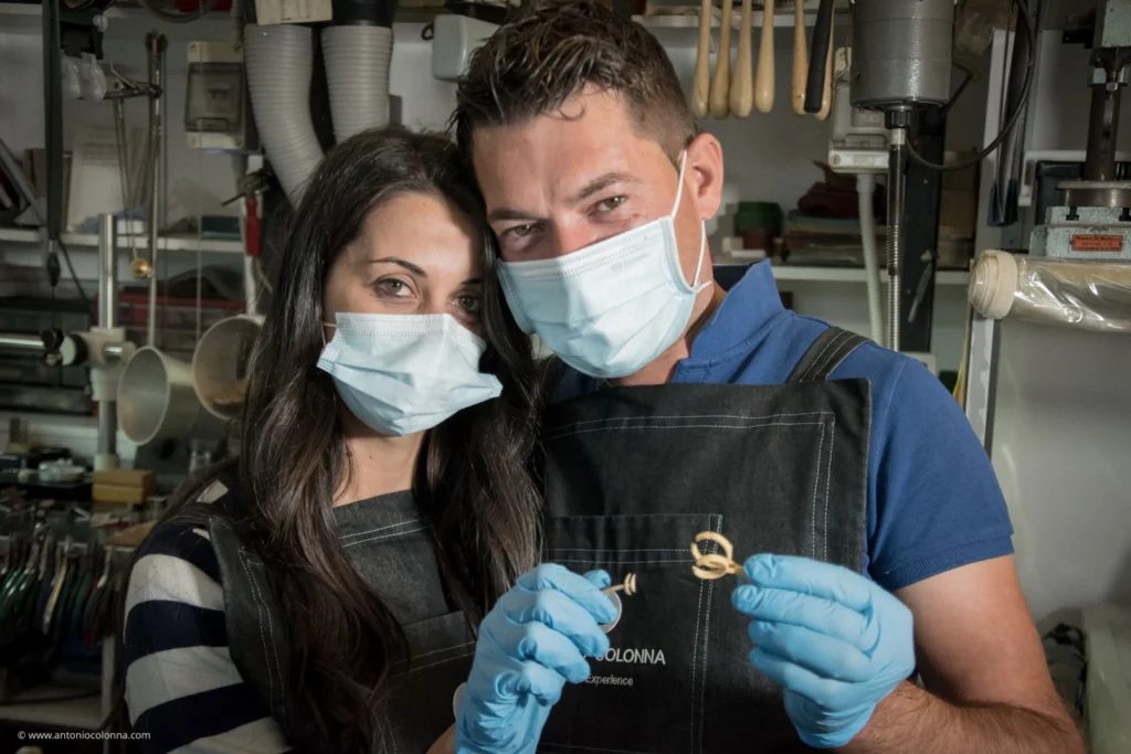 Couple in goldsmith's workshop during the Goldsmiths for a Day experience with a wax model of the jewellery