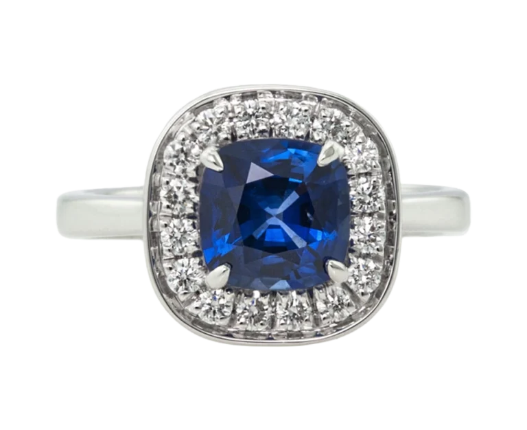 Handmade white gold ring with a cushion-cut blue sapphire and diamonds, custom-made by Antonio Colonna