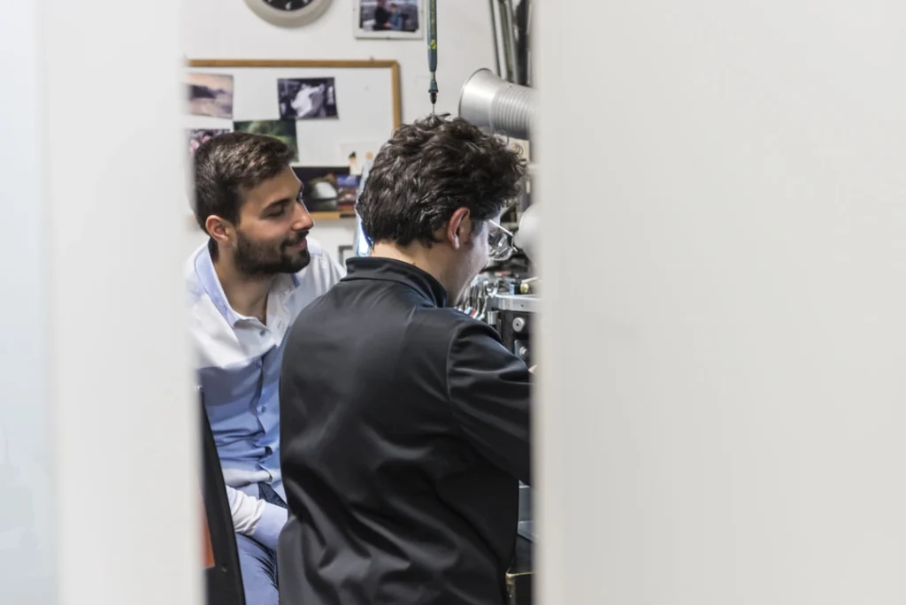 A person sitting with Antonio Colonna during a consultation in a jewellery workshop