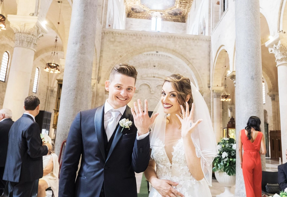 Giuseppe and Veronica on their wedding day with their bespoke wedding bands made by Antonio Colonna.