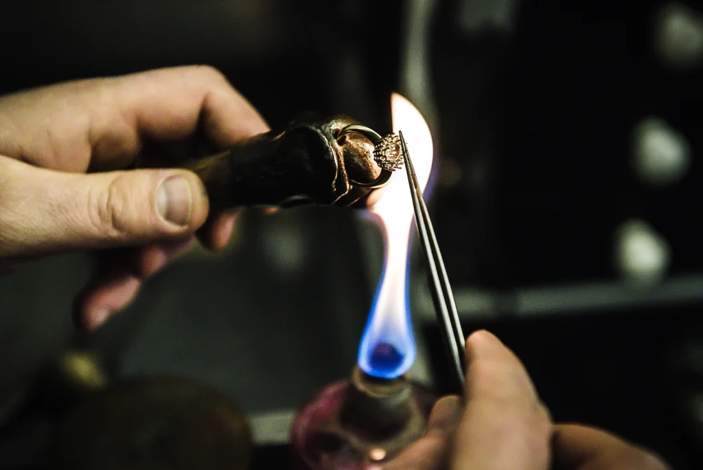 A master goldsmith at work crafting a handmade ring.