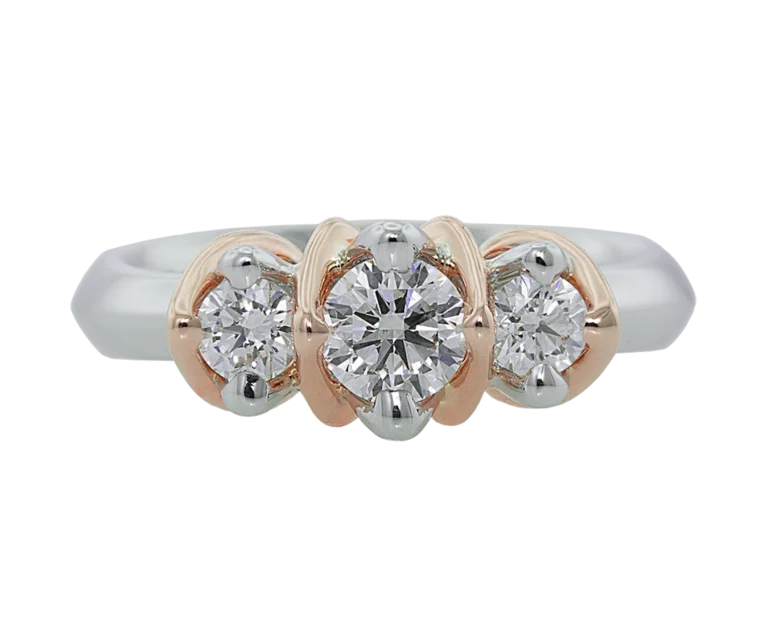 Front view of the Natività ring in white and rose gold with three natural diamonds