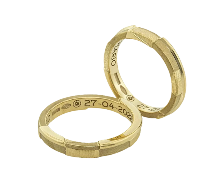 Close-up of the Trinity Narrative Wedding Rings in 18-carat yellow gold