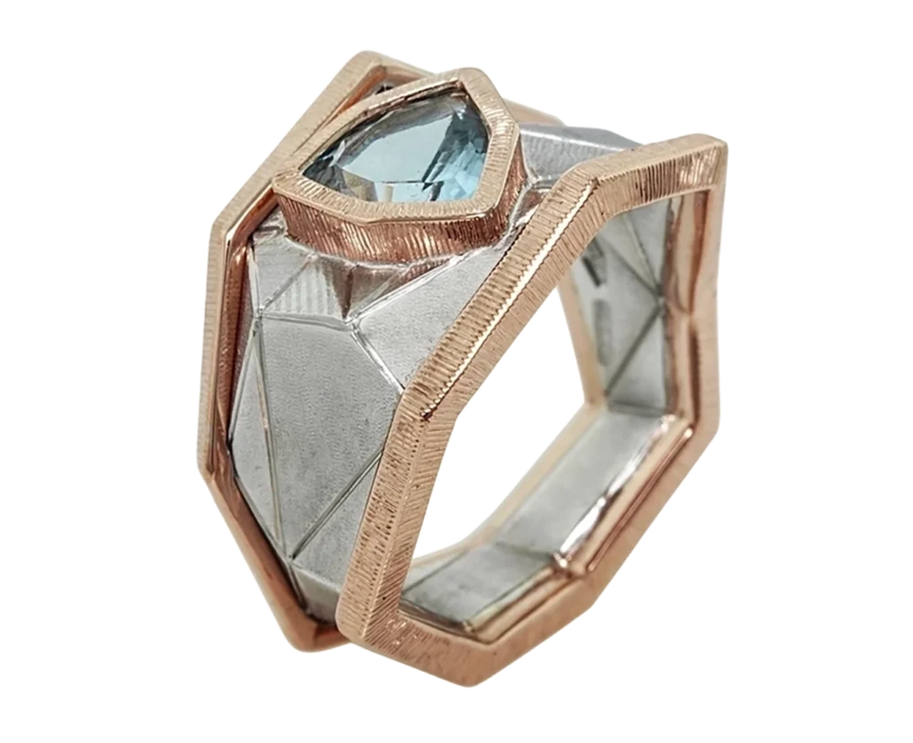 Abstract ring in white gold and rose gold with a trillion-cut aquamarine, three-quarters side view