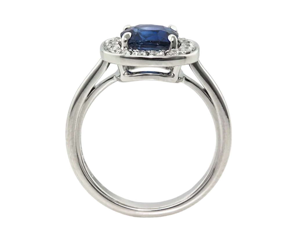 Side view of the claw-set cushion sapphire ring with an open basket