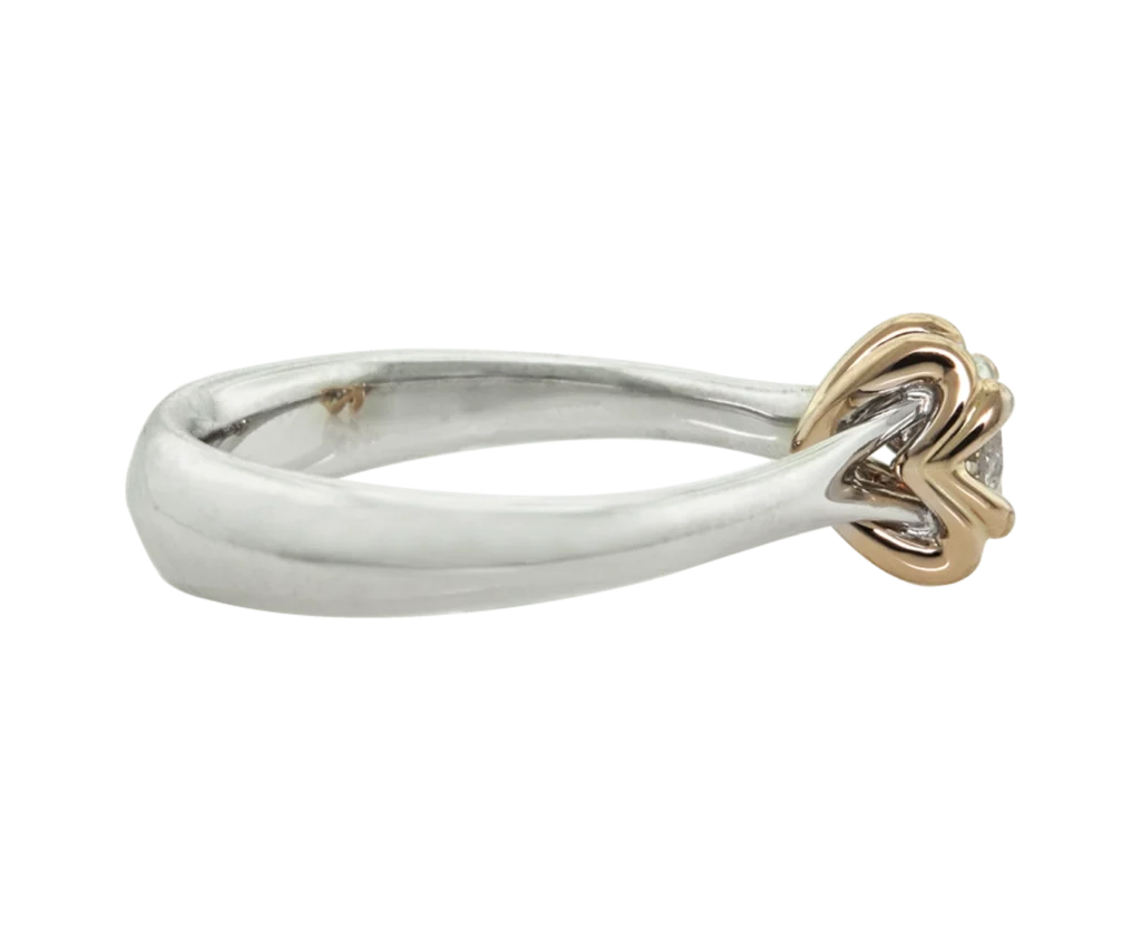 Side view of the Hidden Signs ring in white gold and rose gold with a diamond