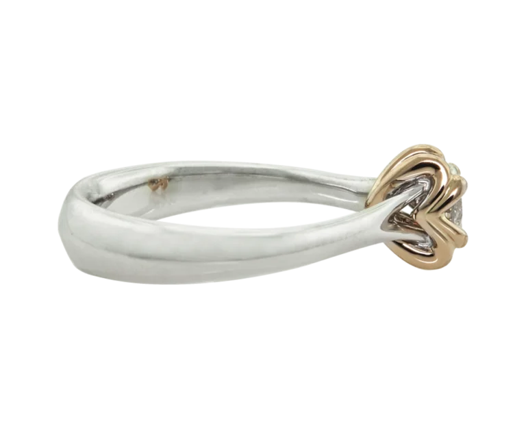 Side view of the Hidden Signs ring in white gold and rose gold with a diamond