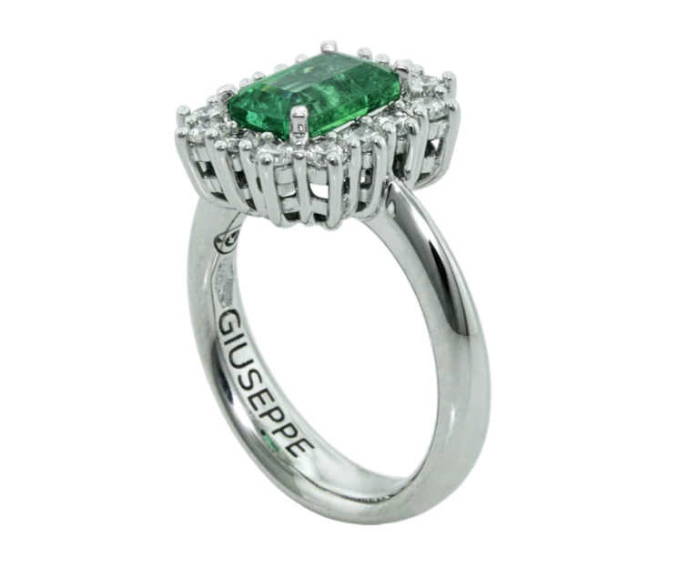 Side view of the emerald-cut ring with an open basket and claw setting