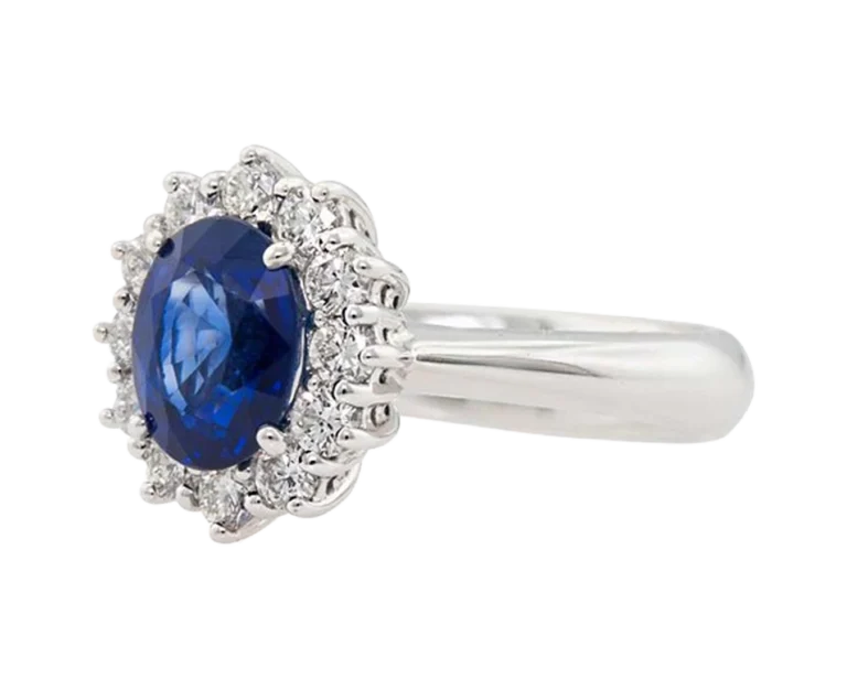Side view of the Classic Sapphire Ring with a claw-set sapphire and diamond halo
