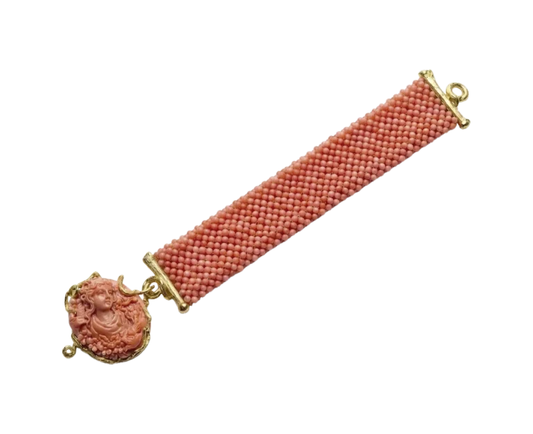Coral bracelet with cameo and yellow gold setting, flat view