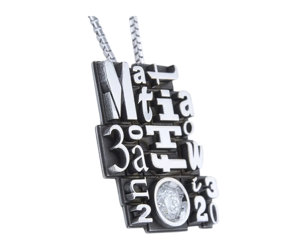 Side view of the Typography pendant with reliefs and diamond