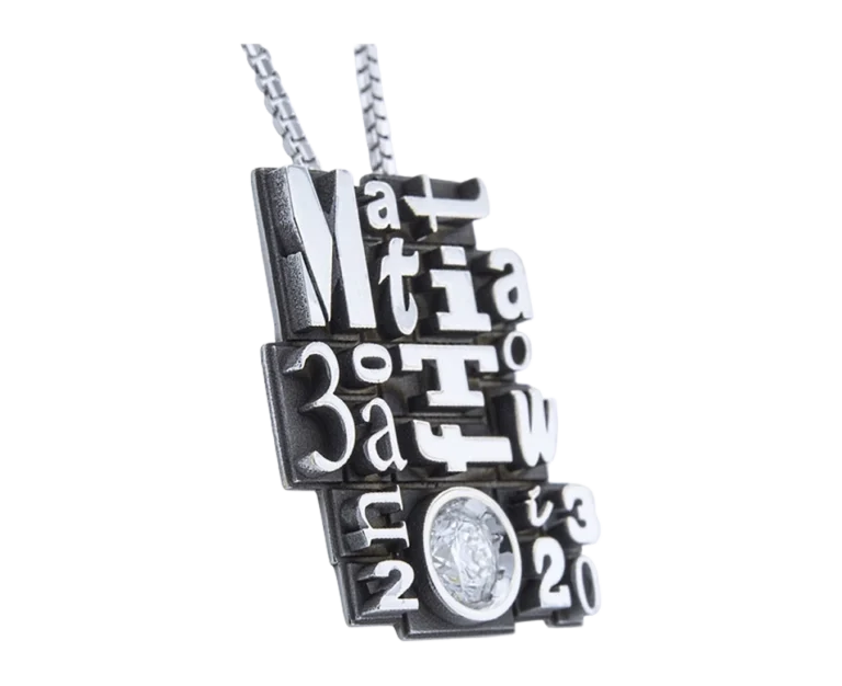 Side view of the Typography pendant with reliefs and diamond